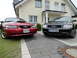 2003 Mercury Marauder - Two cars, a red Ford Mustang and a black Audi A6, are parked on a paved driveway.