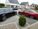 2003 Mercury Marauder - Two cars are parked in a driveway. A red Ford Mustang coupe is on the right, and a black Audi wagon is on the left.