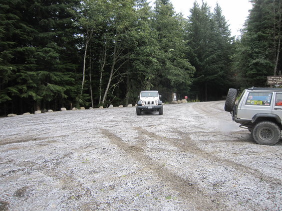 White 2008 Jeep Wrangler parked on a gravel road, facing forward, with a silver Jeep partially visible on the right