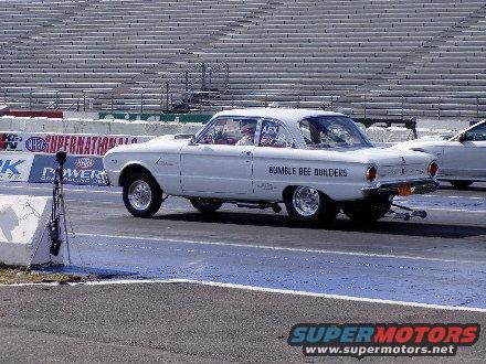 White drag car with "BUMBLE BEE BUILDERS" text on the side, seen from a 3/4 front angle on a race track