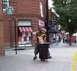 1971 Ford Ranchero - A man discards food into a public trash receptacle on a busy street corner.