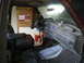 1988 Ford Bronco - The interior of a vehicle is shown, with a large box and a gas can in the background.