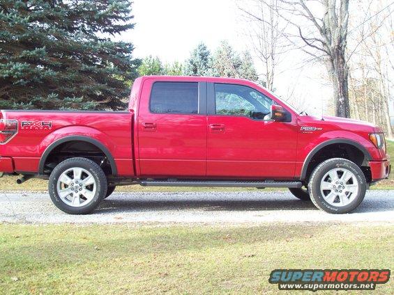 Red Ford F-150 SuperCrew pickup truck, side view