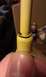 1984 Ford Bronco - A yellow automotive part is held by a finger, with a black O-ring visible.