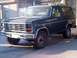 1985 Ford Bronco - This 1985 Ford Bronco is seen in a 3/4 front view, parked in a driveway.