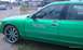 2002 Ford Crown Victoria - A green sedan with custom rims and 'Ms Bliss' lettering on the driver's side door.