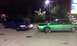 2002 Ford Crown Victoria - Two Ford Crown Victorias, one green with custom rims and one blue, are parked side-by-side at night.