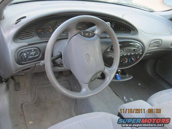 Interior view of a car, showing the dashboard, steering wheel, and seats. Date stamp reads 11/16/2011