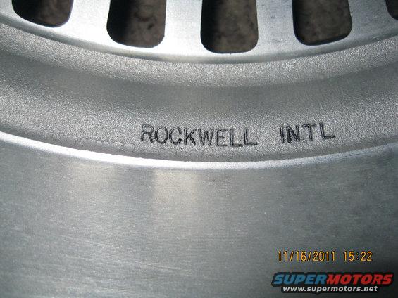 Close-up of a metal wheel rim with 'ROCKWELL INTL' stamped on it