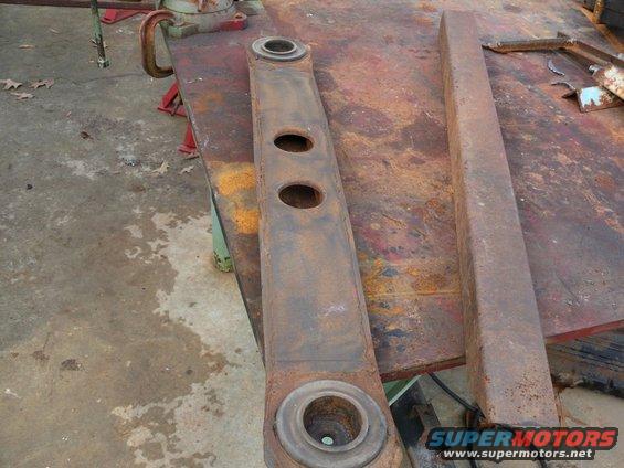 Rusty metal suspension part with two holes and circular ends