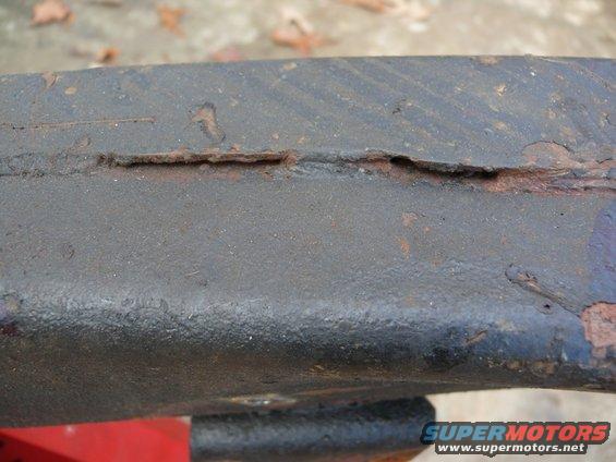 Close-up of rusted metal frame with visible crack