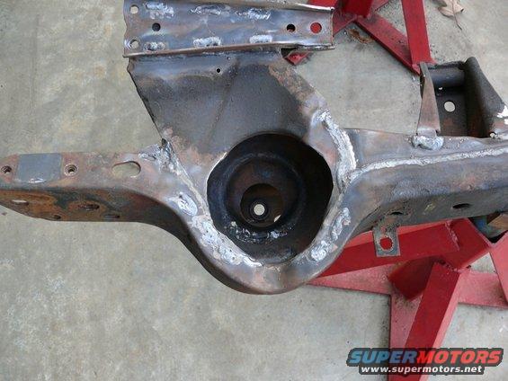 close-up of a rusty car frame section on red stands