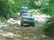 1989 Ford Bronco - A 1987 Ford Bronco navigates a challenging rocky trail with other vehicles behind it.