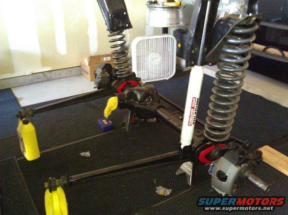 Front axle assembly with coil springs and shock absorber, disassembled