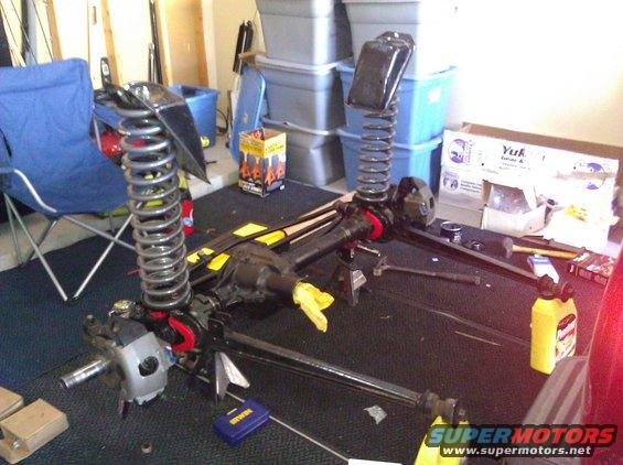 Front axle and suspension components with large coil springs