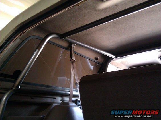 Interior view of a vehicle's roll cage and seatbelt