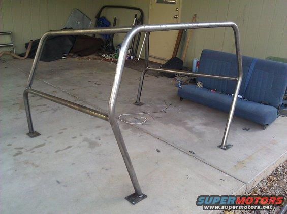 Metal roll cage with four mounting plates, two horizontal bars, and two vertical supports