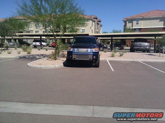 Front view of a dark blue 2008 Nissan Titan pickup truck parked in a lot
