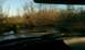 1992 Ford Bronco - The vehicle's dashboard is visible as it drives through a flooded area with bare trees in the background.