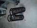 1996 Ford Bronco - Two black coil springs are shown on a concrete floor, possibly for sale or repair.