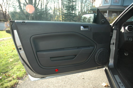 2008 Ford Mustang interior door panel with speaker and SVT sill plate
