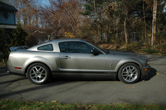 Silver 2008 Ford Mustang Shelby GT500 parked on asphalt, side view