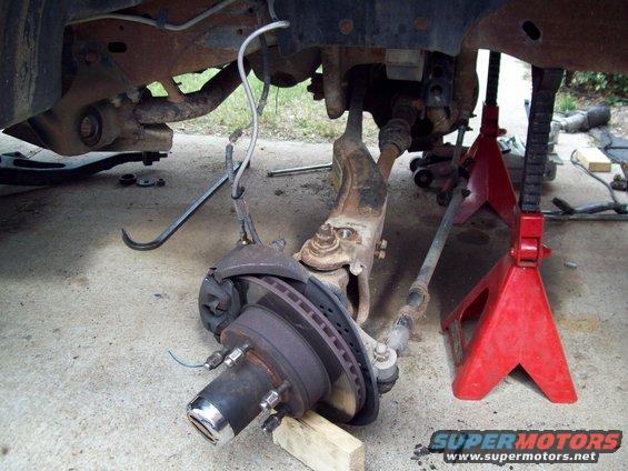vehicle's front suspension and brake rotor assembly on jack stands