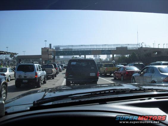 Traffic jam at a border crossing with multiple cars and trucks lined up