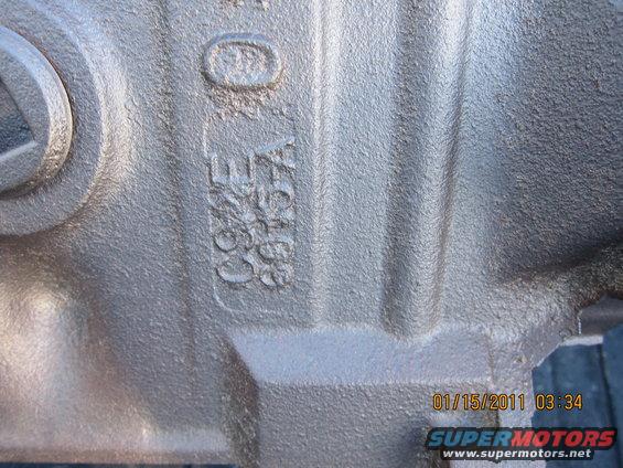 Close-up of a metal part with embossed casting numbers C9ZE-A 6030-A