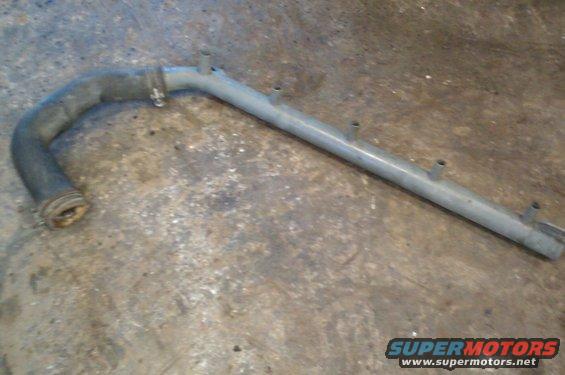 Metal coolant pipe with a black rubber hose attached to one end