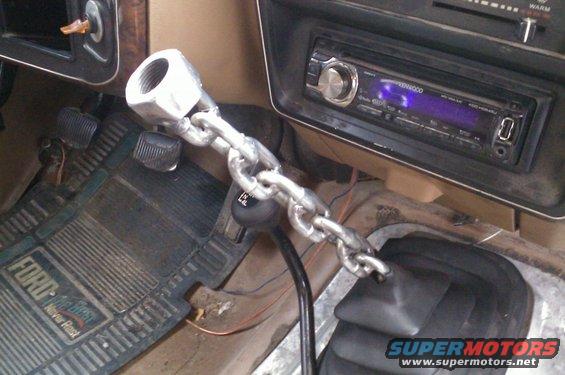 Interior view of a Ford truck with a custom chain shift knob and aftermarket Kenwood stereo