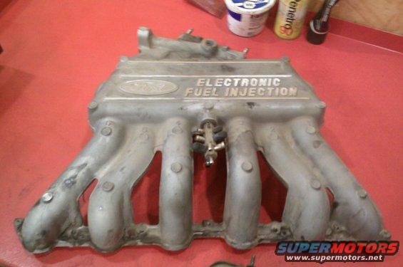 Ford electronic fuel injection intake manifold with visible Ford oval logo