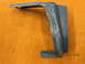 1969 Ford Mustang - A blue metal bracket with etched measurement markings is shown against an orange textured background.