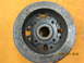 1969 Ford Mustang - A close-up view of a metal automotive part, likely a pulley or flywheel, with visible markings and wear.