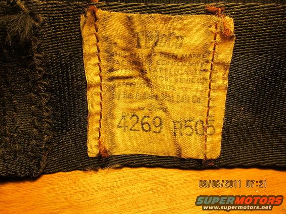 Yellow fabric label with black text and numbers '4269 R505' sewn onto dark material