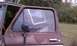 1979 Ford Bronco - A weathered 1978 Ford Bronco sits outdoors with its driver's side door ajar.