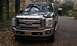 2009 Ford F-150 - Black Ford F-Series truck parked outdoors with a chrome grille and a custom license plate.