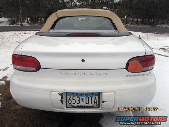 White convertible with a tan top, rear view. The Chrysler logo is visible on the trunk