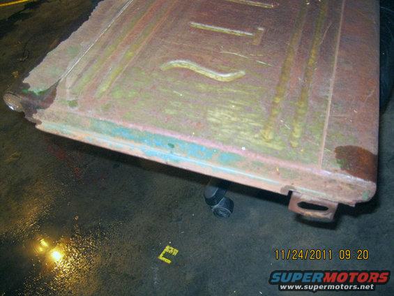 rusted metal panel with embossed lines and some blue paint