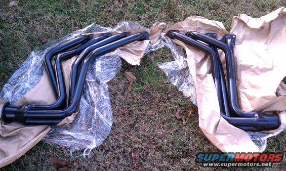 Pair of black exhaust headers on grass