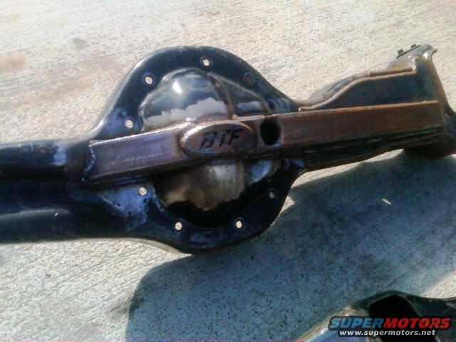 Differential housing with 'BTF' marking, showing wear and some rust