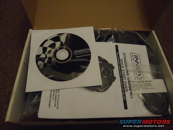 Innovate Motorsports standalone gauge kit in an open box with a CD and quick start guide