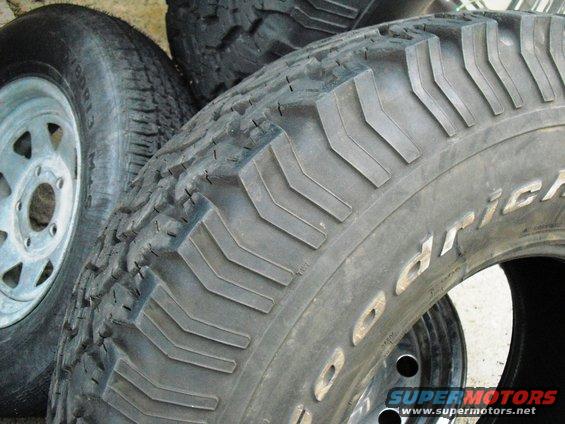 Stack of BFGoodrich All-Terrain tires, one with a silver rim