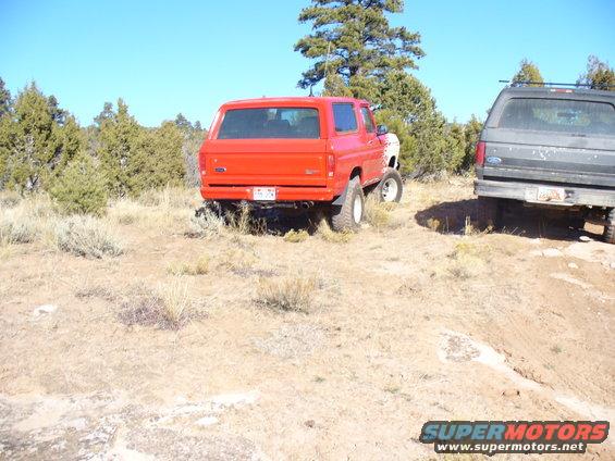 1979 Ford Bronco and a dark SUV parked off-road