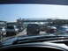 1986 Ford Bronco - Vehicles are backed up in a traffic jam, with a large overpass structure visible in the background.