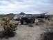 1986 Ford Bronco - A black 1992 Ford Bronco is parked at a desert campsite, with tents and mountains in the background.