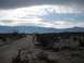 1986 Ford Bronco - Desert scene with mountains and a dirt road, several people.