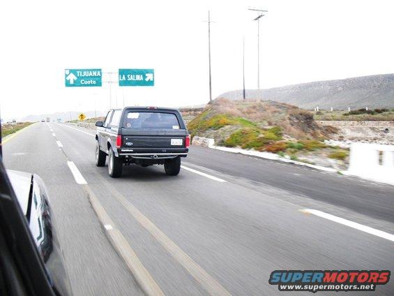 Black Ford Bronco driving on highway, signs for Tijuana and La Salina visible