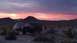 1986 Ford Bronco - Desert campsite scene with a Ford Bronco and tent under a vibrant sunset sky.