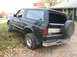 1993 Ford Bronco - Rear view of a 1993 Ford Bronco with a spare tire on the tailgate.
